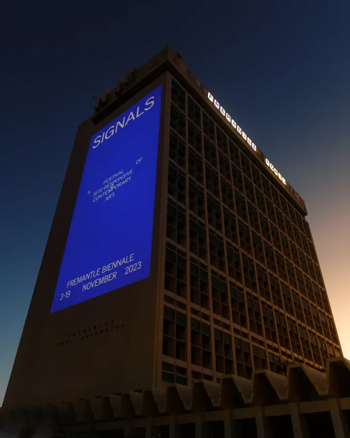 Signals projected onto the Fremantle Ports building at dusk