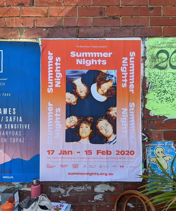 Orange Summer Nights street poster with an ensemble portrait on a brick wall