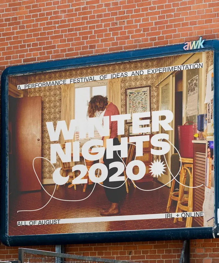 Winter Nights artist-at-home campaign on a framed billboard outside a brick building