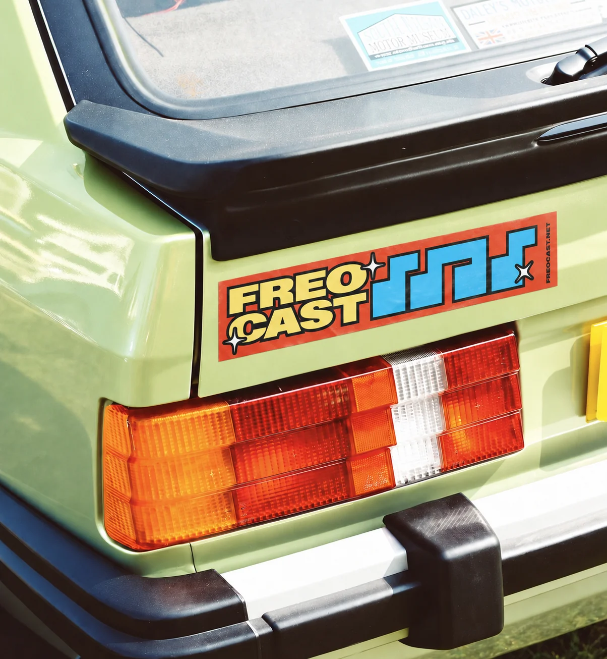 Colourful FREOCAST bumper sticker on a lime-green vintage car