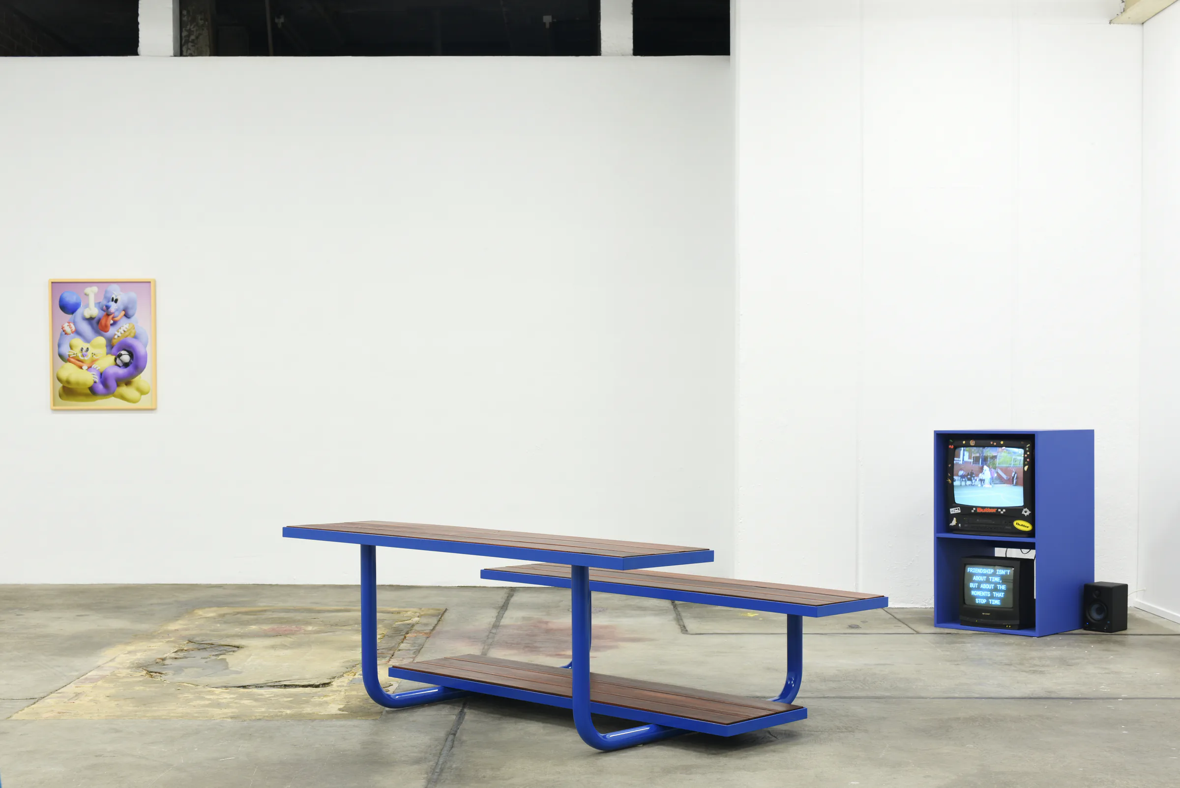 Custom blue picnic table and video cabinet bringing Sports Dreams into the gallery