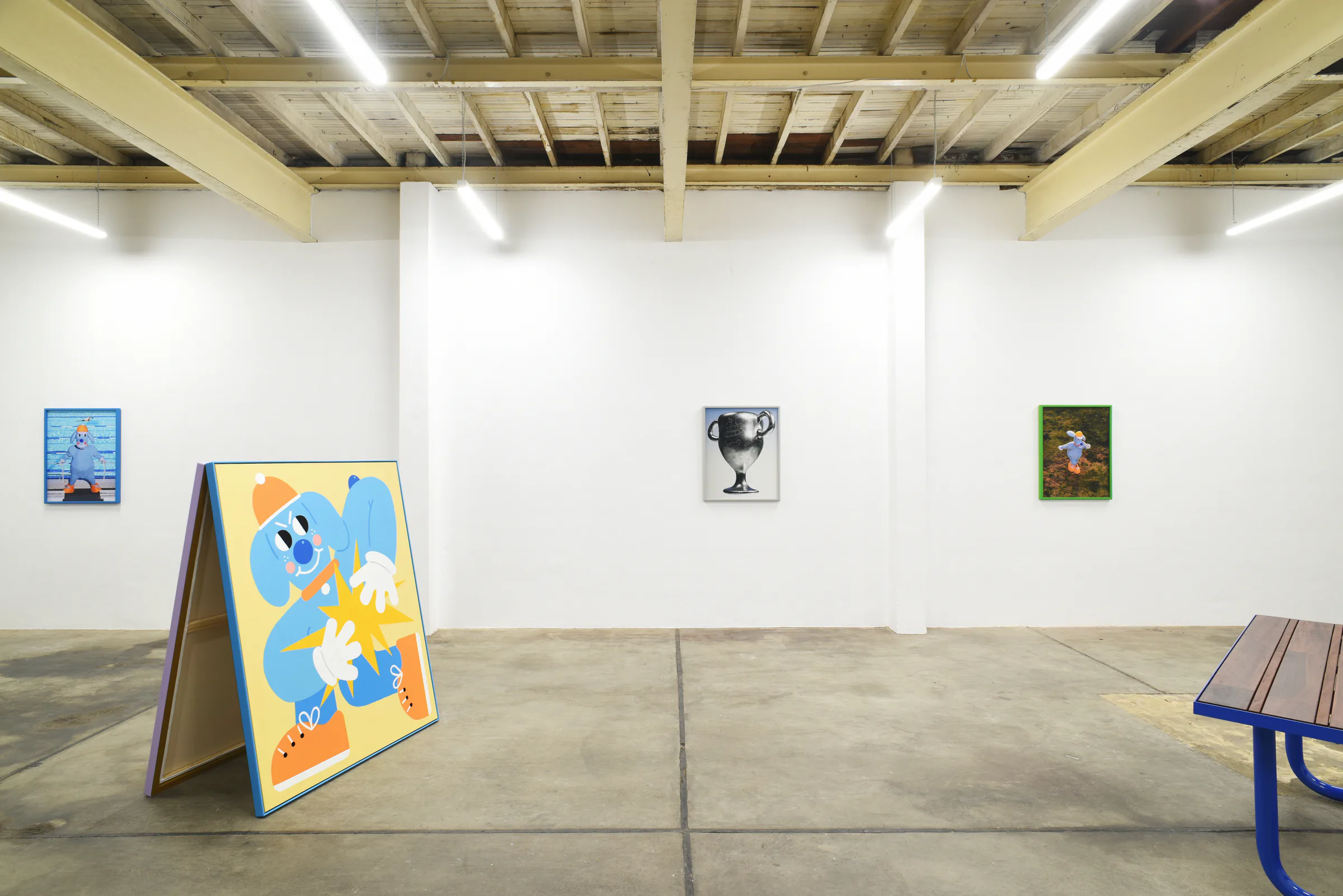 Wide view of the Sports Dreams exhibition with the freestanding blue character painting