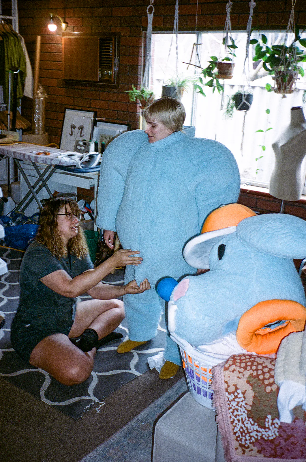 Fitting the full-size blue Sports Dreams mascot head and costume in the studio