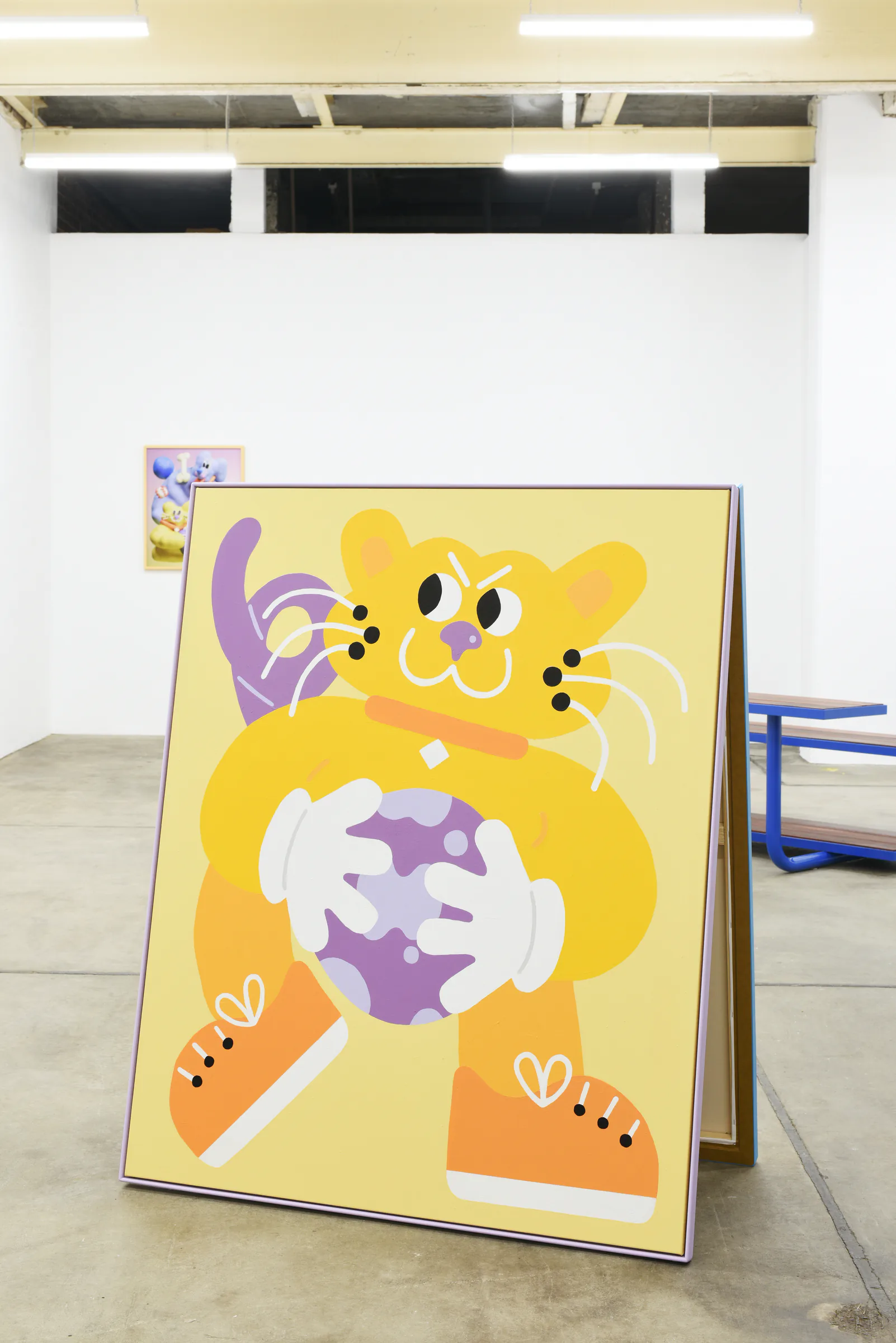 Yellow Sports Dreams character painting on a freestanding exhibition frame